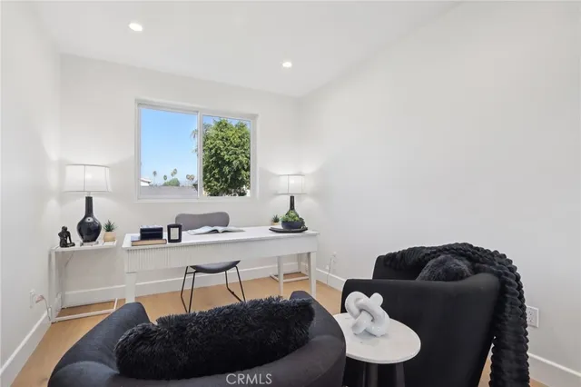a bed room with a bed and a potted plant