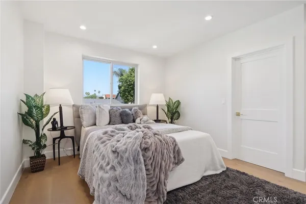 a bedroom with a bed and a view of kitchen