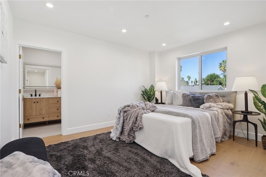 14929 Vose Street Van Nuys, CA 91405 - Photo 19 of 56 a bedroom with a bed and a view of kitchen