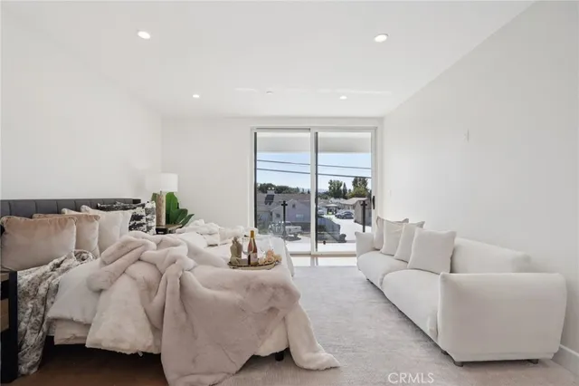 a bedroom with a bed and a potted plant