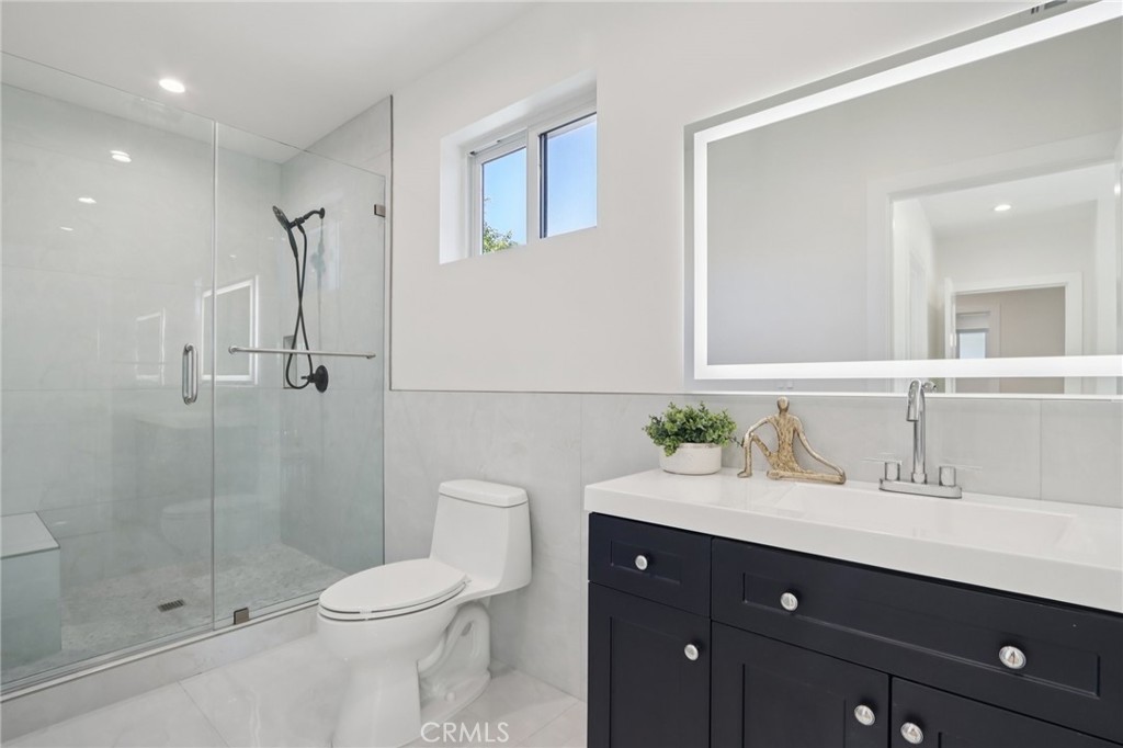 14929 Vose Street Van Nuys, CA 91405 - Photo 25 of 56 a bathroom with a sink vanity mirror and toilet