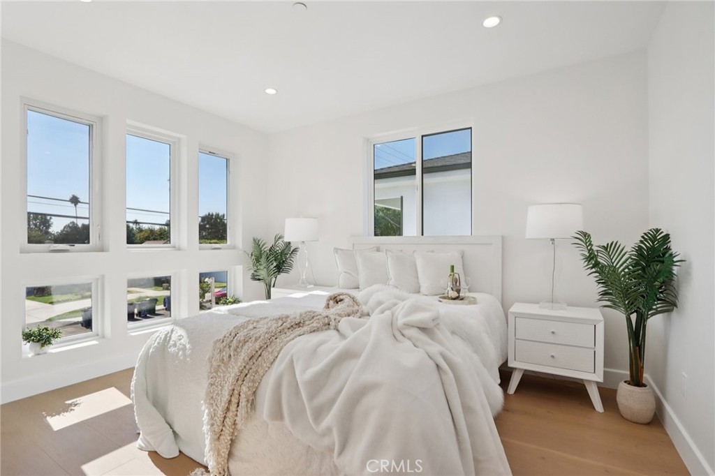 14929 Vose Street Van Nuys, CA 91405 - Photo 26 of 56 a bedroom with a bed and a potted plant