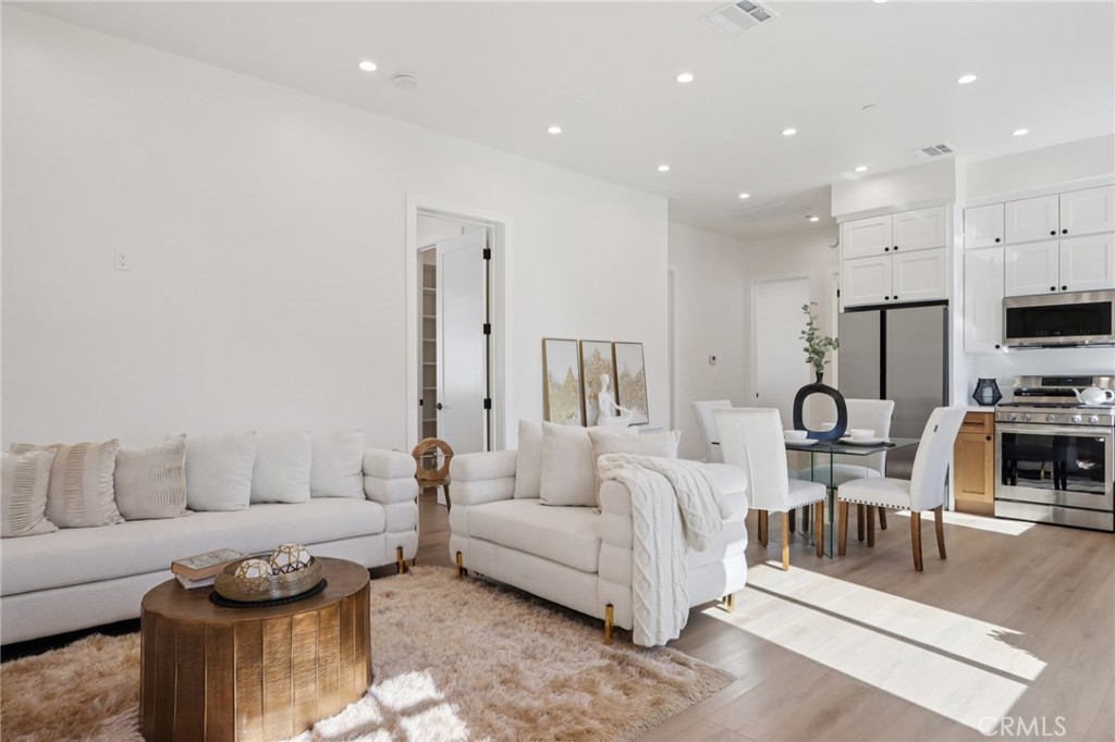 14929 Vose Street Van Nuys, CA 91405 - Photo 35 of 56 a living room with furniture and a flat screen tv
