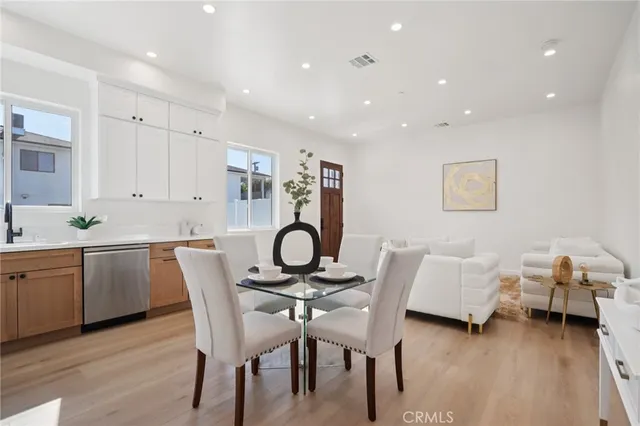 a view of a room with wooden floor and white walls