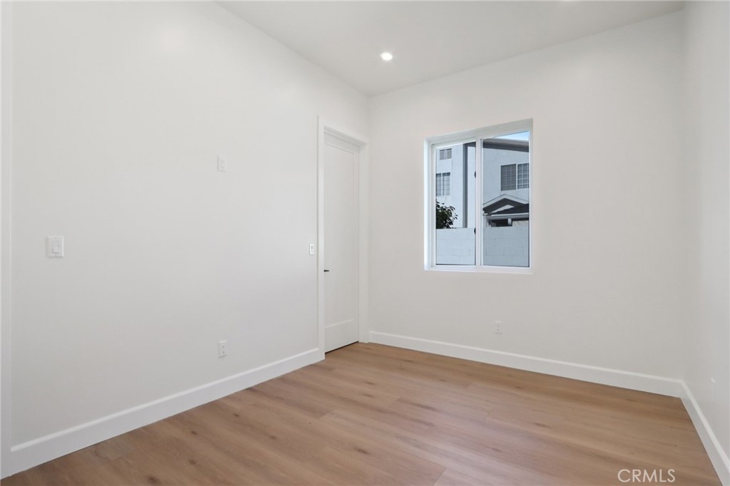 14929 Vose Street Van Nuys, CA 91405 - Photo 42 of 56 a view of a room with wooden floor and white walls