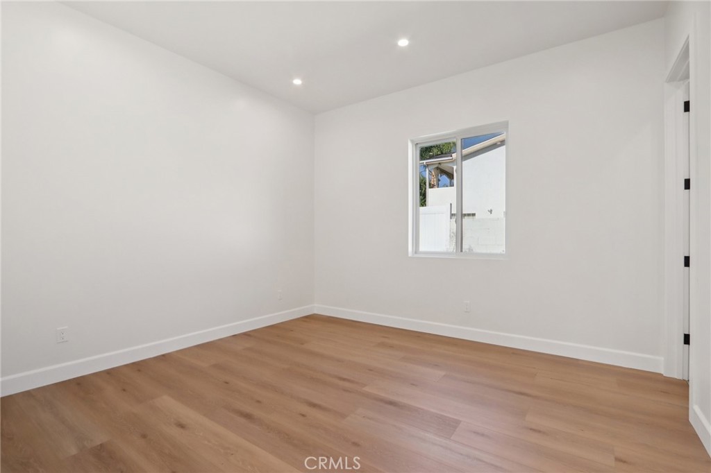 14929 Vose Street Van Nuys, CA 91405 - Photo 46 of 56 an empty room with wooden floor and window