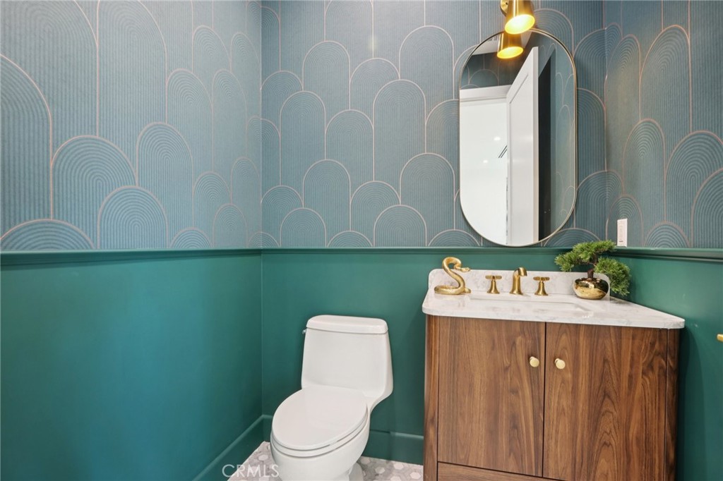 14929 Vose Street Van Nuys, CA 91405 - Photo 8 of 56 a bathroom with a toilet sink and mirror