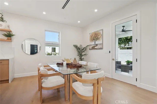 a living room with stainless steel appliances kitchen island granite countertop a kitchen view and a dining table