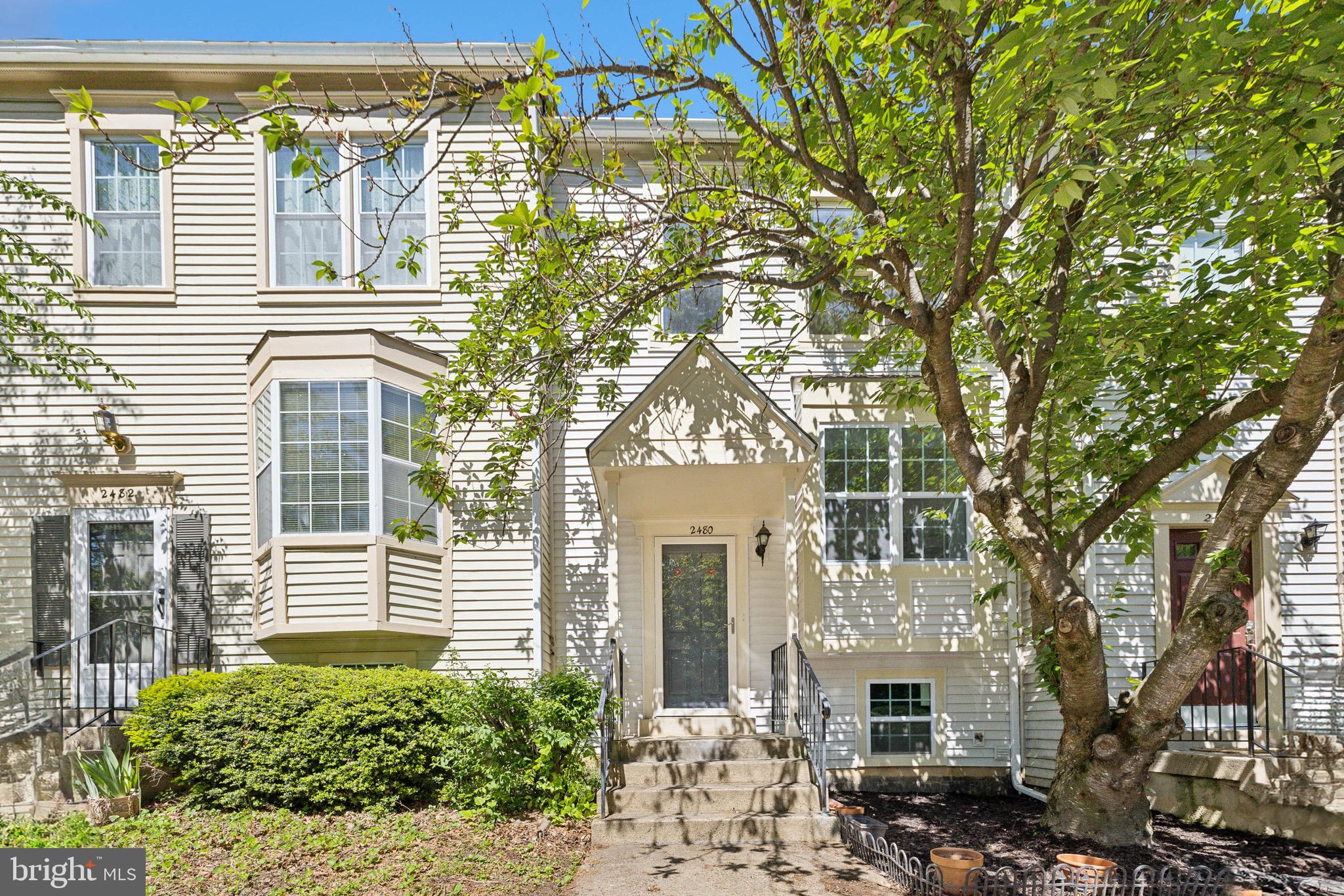 2480 Ridgehampton Court Reston, VA 20191 - Photo 1 of 25 a front view of a house with a tree