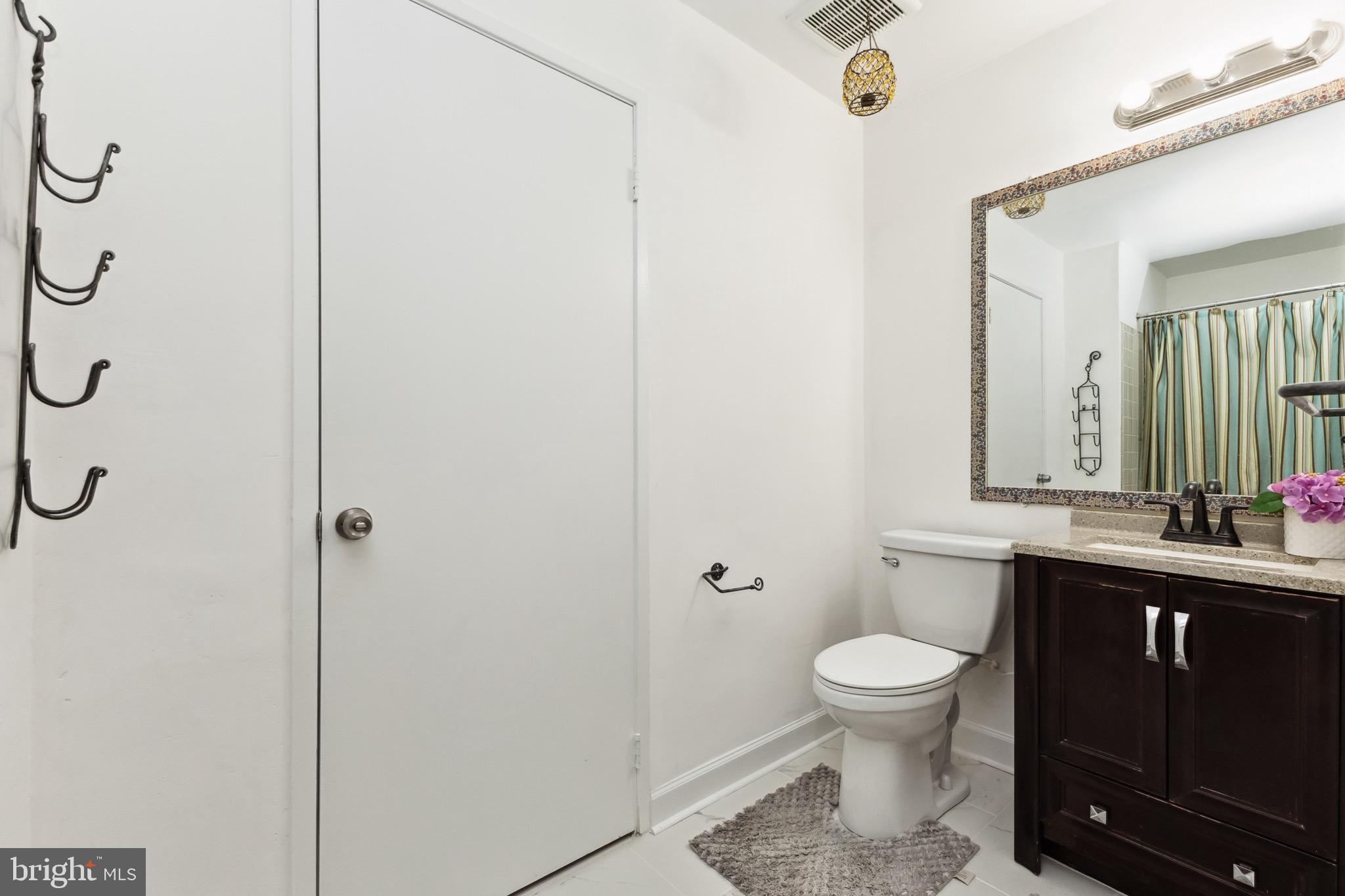 2480 Ridgehampton Court Reston, VA 20191 - Photo 18 of 25 a bathroom with a toilet sink shower and mirror