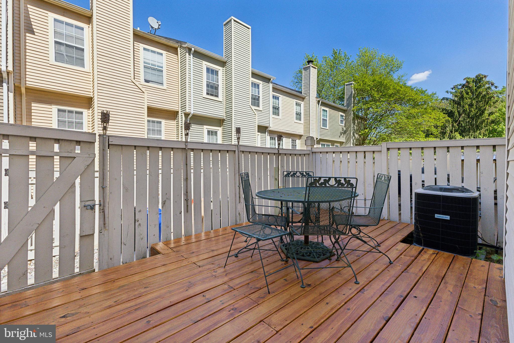 2480 Ridgehampton Court Reston, VA 20191 - Photo 23 of 25 a view of a deck with table and chairs and wooden floor