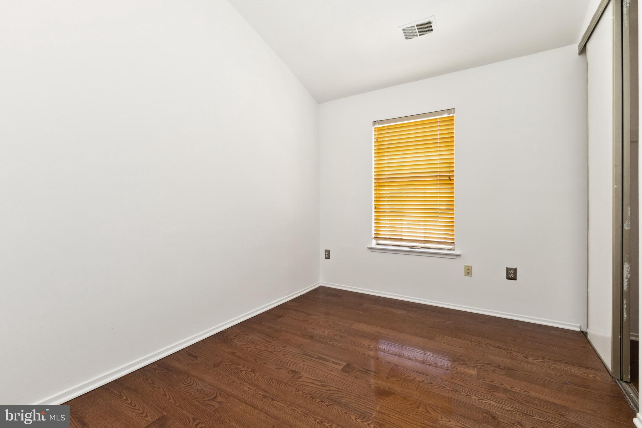 2480 Ridgehampton Court Reston, VA 20191 - Photo 10 of 25 a view of an empty room with wooden floor and a window