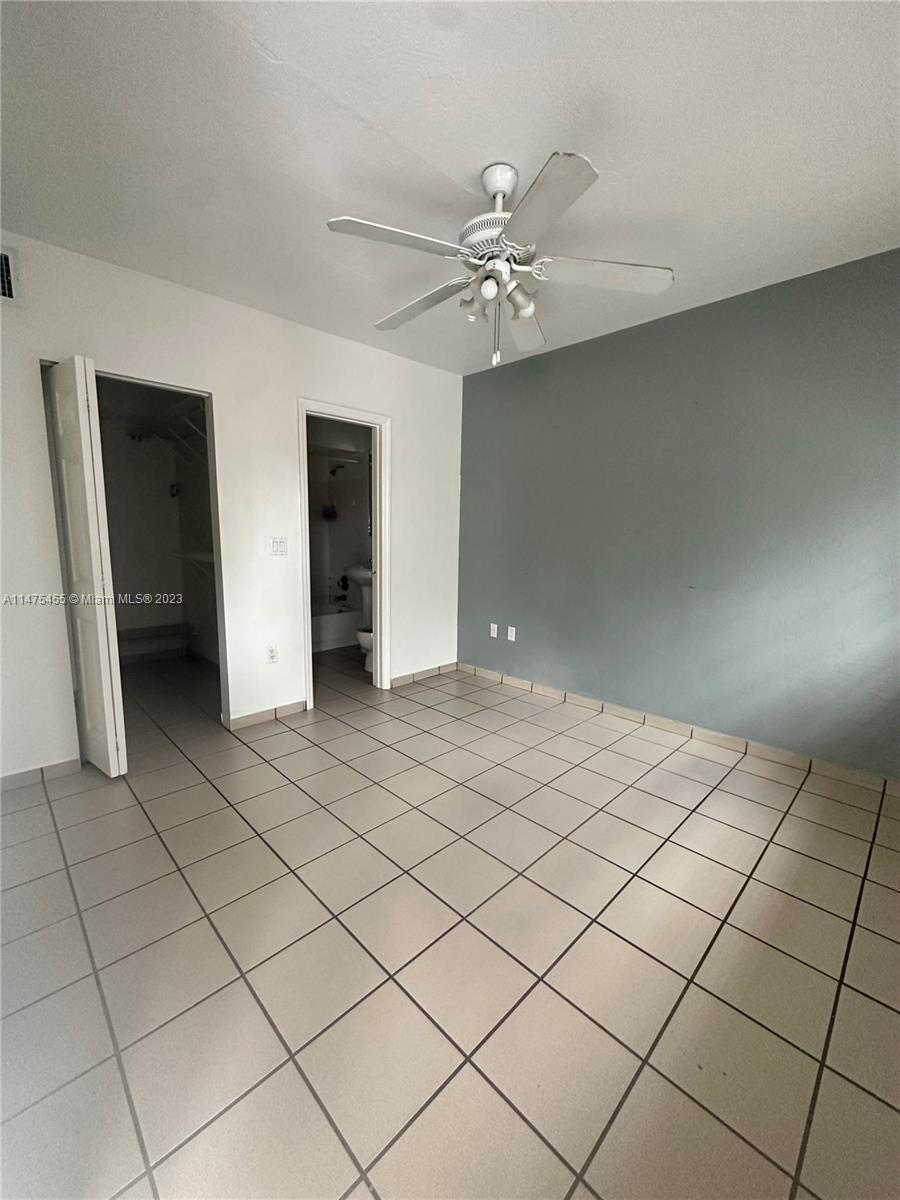 7075 Southwest 14th Street, Unit 1 Miami, FL 33144 - Photo 8 of 10 a view of an empty room and chandelier fan