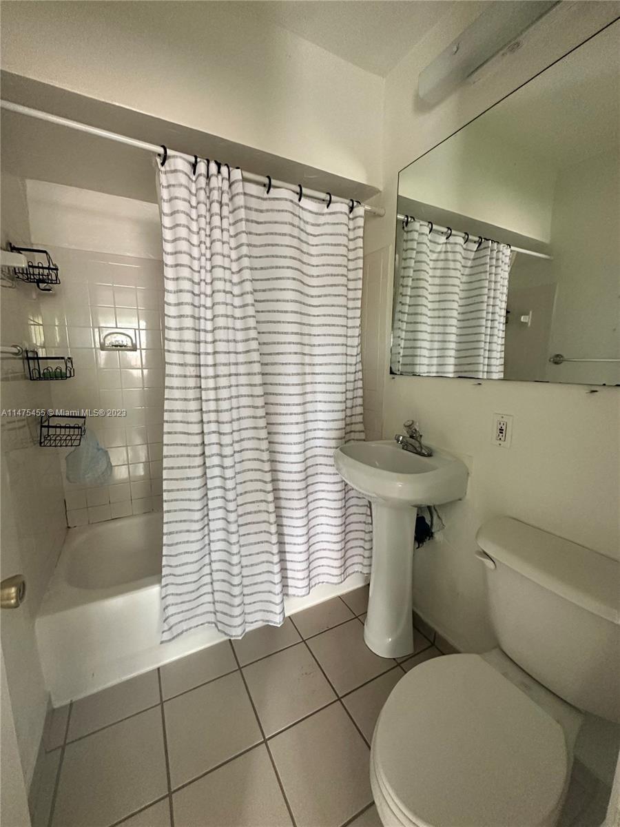 7075 Southwest 14th Street, Unit 1 Miami, FL 33144 - Photo 10 of 10 a bathroom with a toilet and a shower