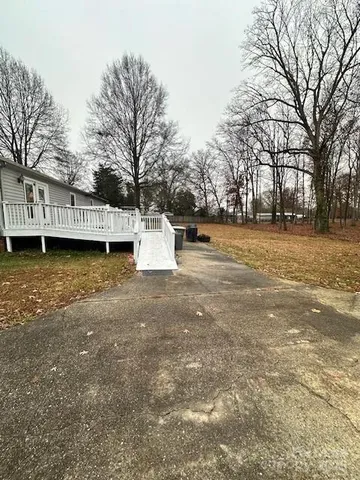 a wooden bench sitting in middle of a yard