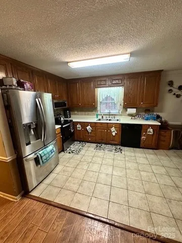 a kitchen with stainless steel appliances a refrigerator sink and cabinets