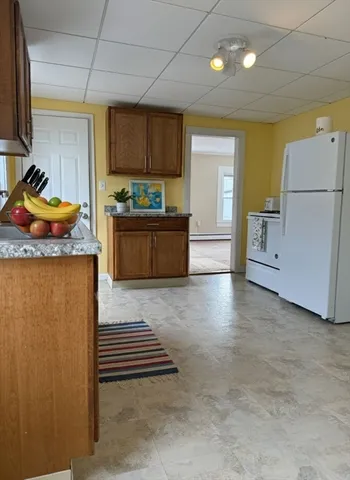 a kitchen with stainless steel appliances granite countertop a refrigerator a stove and a sink