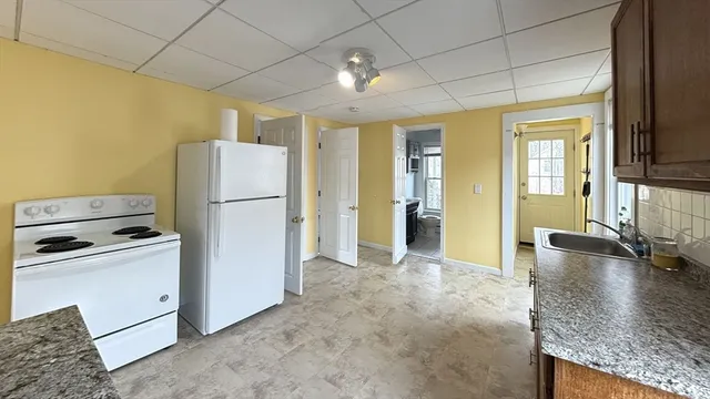 a kitchen with refrigerator and windows