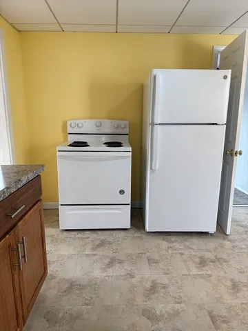 a white refrigerator freezer sitting in a kitchen