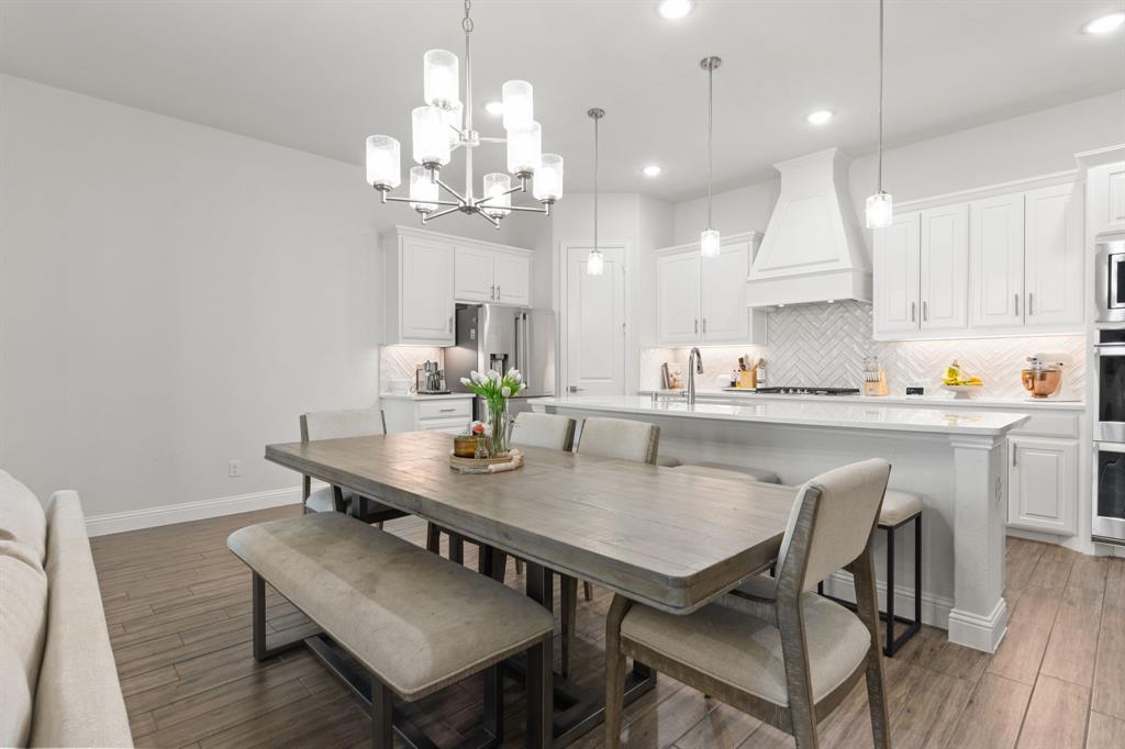 8808 Royal Star Road Rowlett, TX 75089 - Photo 18 of 40 a kitchen with a dining table chairs and microwave