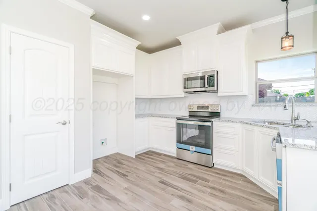 a kitchen with a refrigerator and a stove top oven