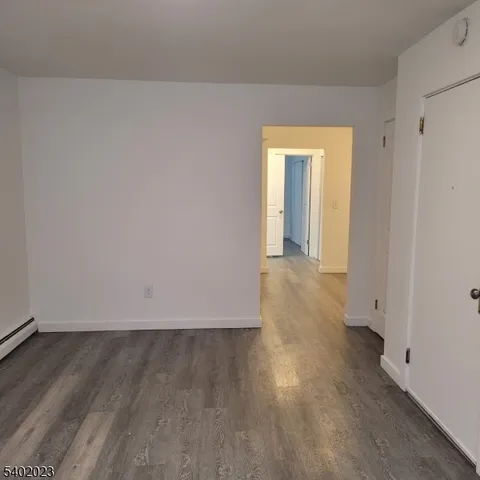 a view of a room with wooden floor