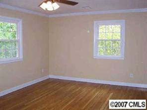 14540 Cabarrus Station Road Midland, NC 28107 - Photo 8 of 8 a view of an empty room with wooden floor and a window