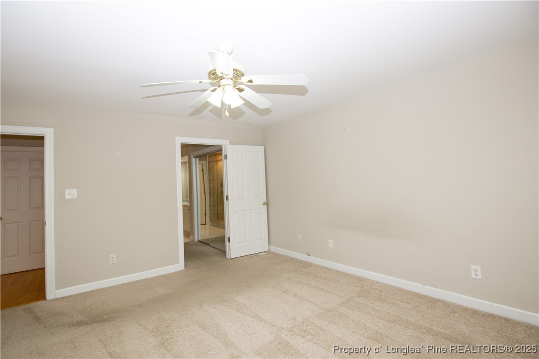 175 Knoll Road Southern Pines, NC 28387 - Photo 27 of 50 an empty room with a bathroom and a ceiling fan