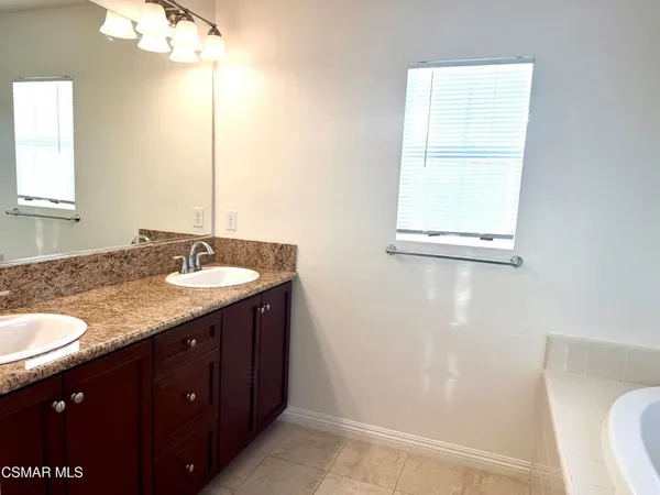 a bathroom with a granite countertop sink toilet and a mirror