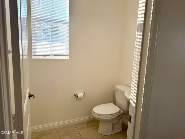 a white toilet sitting next to a bathroom sink