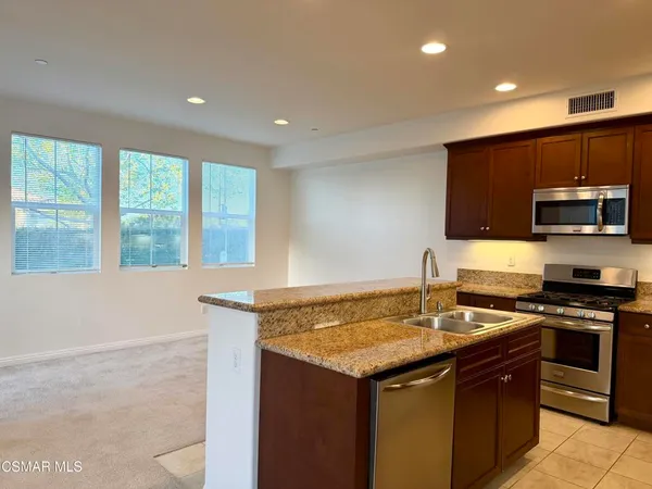 a kitchen with a stove a sink and a microwave