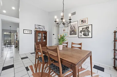 a view of a dining room with furniture and chandelier