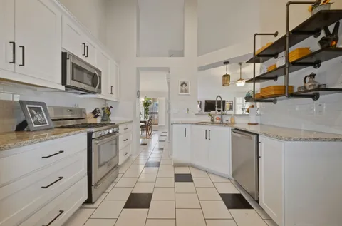 a kitchen with stainless steel appliances granite countertop a sink and cabinets