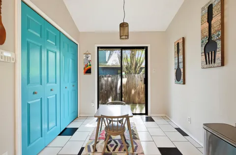 a view of a hallway with wooden floor and dining room