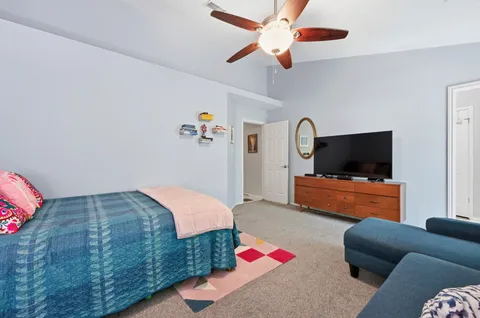 a bedroom with furniture and a flat screen tv