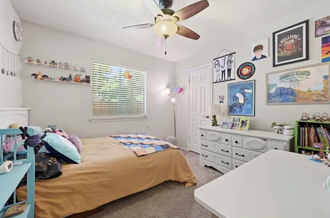 a bedroom with two beds and a chandelier