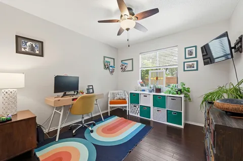 a view of a workspace with furniture and a living room