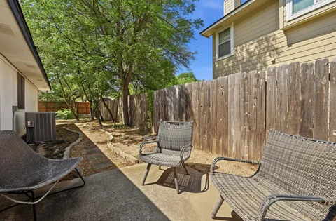 a view of backyard with a table and chairs