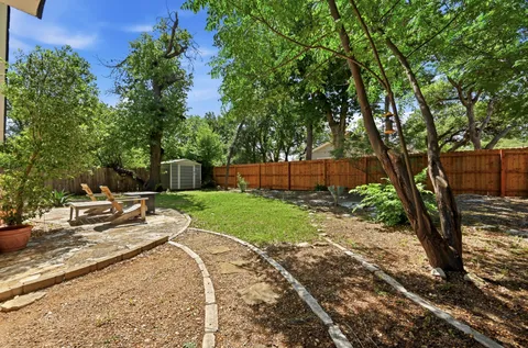 a view of a backyard with sitting area