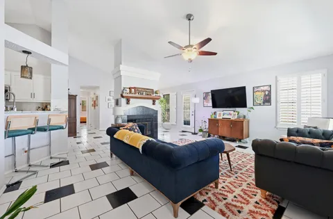 a living room with furniture a flat screen tv and a fireplace