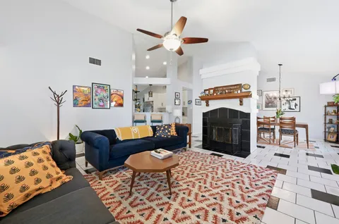 a living room with furniture a rug and a fireplace
