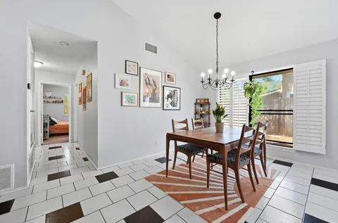 a view of a dining room with furniture and chandelier