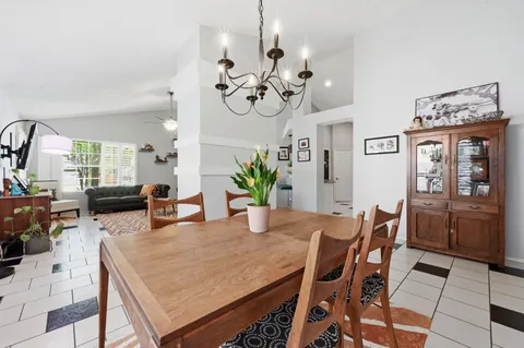 a view of a dining room with furniture and chandelier