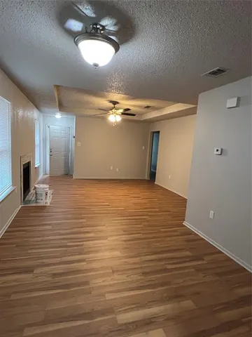 a view of a room with wooden floor