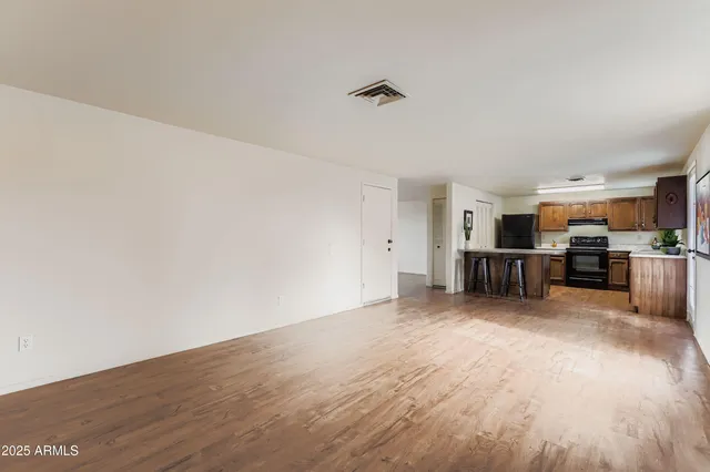 a view of a kitchen with wooden floor