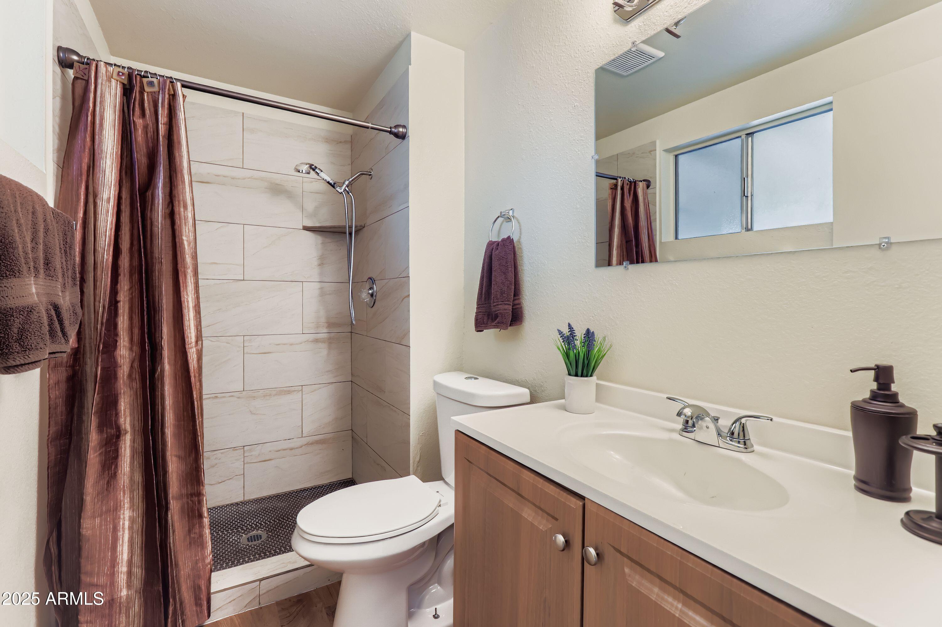 1619 West El Alba Way Chandler, AZ 85224 - Photo 16 of 26 a bathroom with a sink toilet and shower