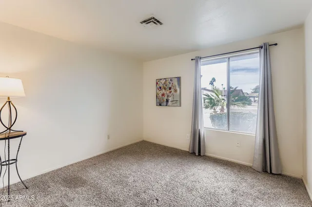 an empty room with windows and closet