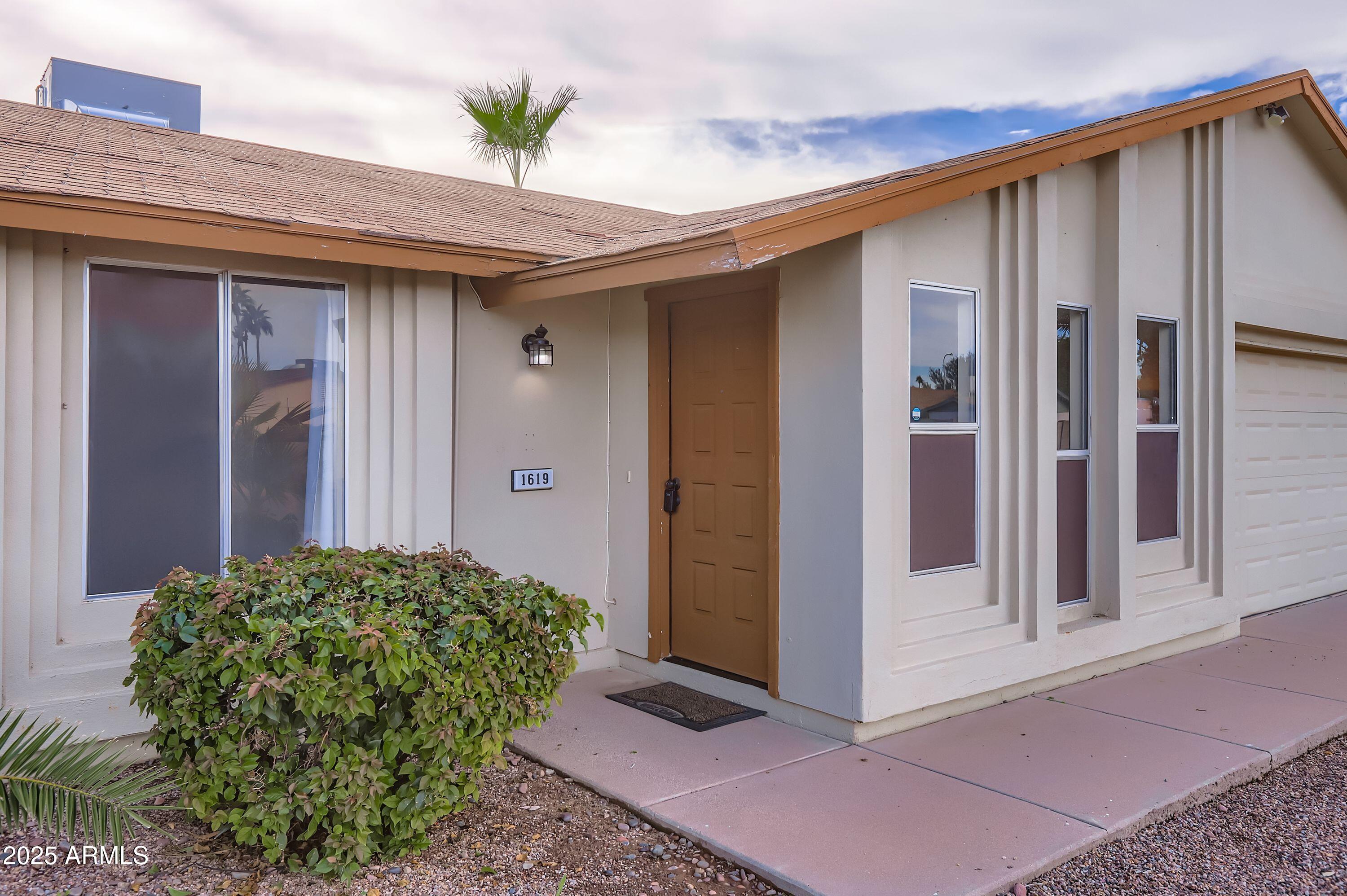 1619 West El Alba Way Chandler, AZ 85224 - Photo 3 of 26 a view of a house with a glass door