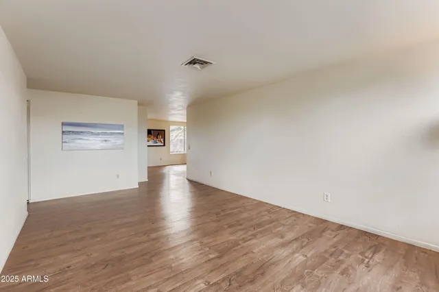 a view of a kitchen with wooden floor and a kitchen