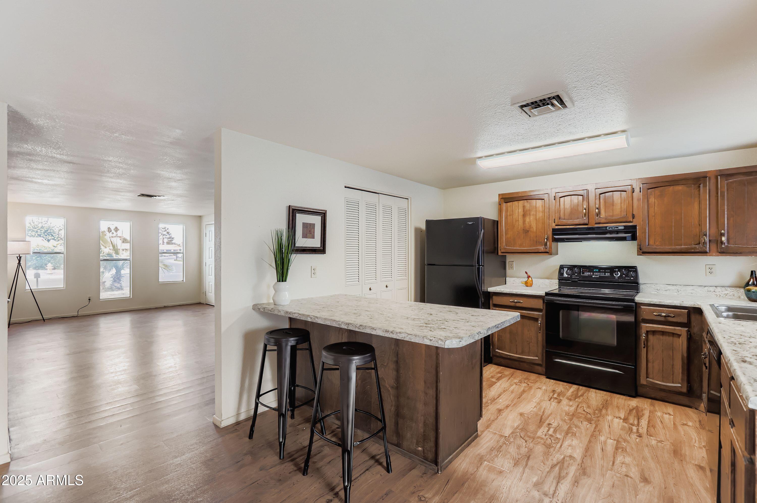 1619 West El Alba Way Chandler, AZ 85224 - Photo 6 of 26 a kitchen with stainless steel appliances granite countertop a stove top oven a sink a counter space and cabinets